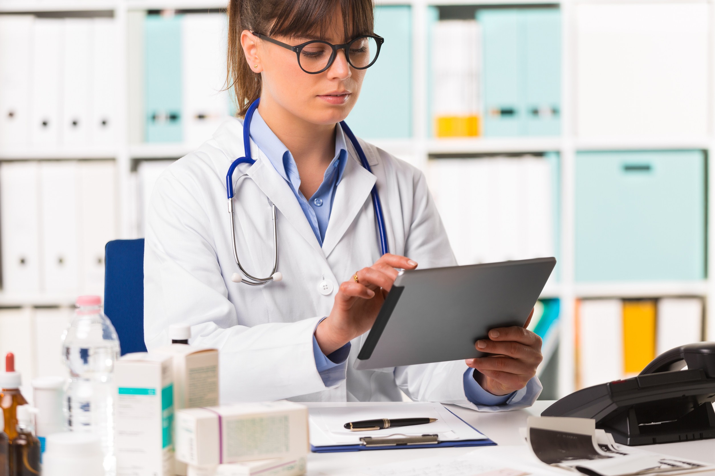 Doctor reviewing electronic medical records on tablet