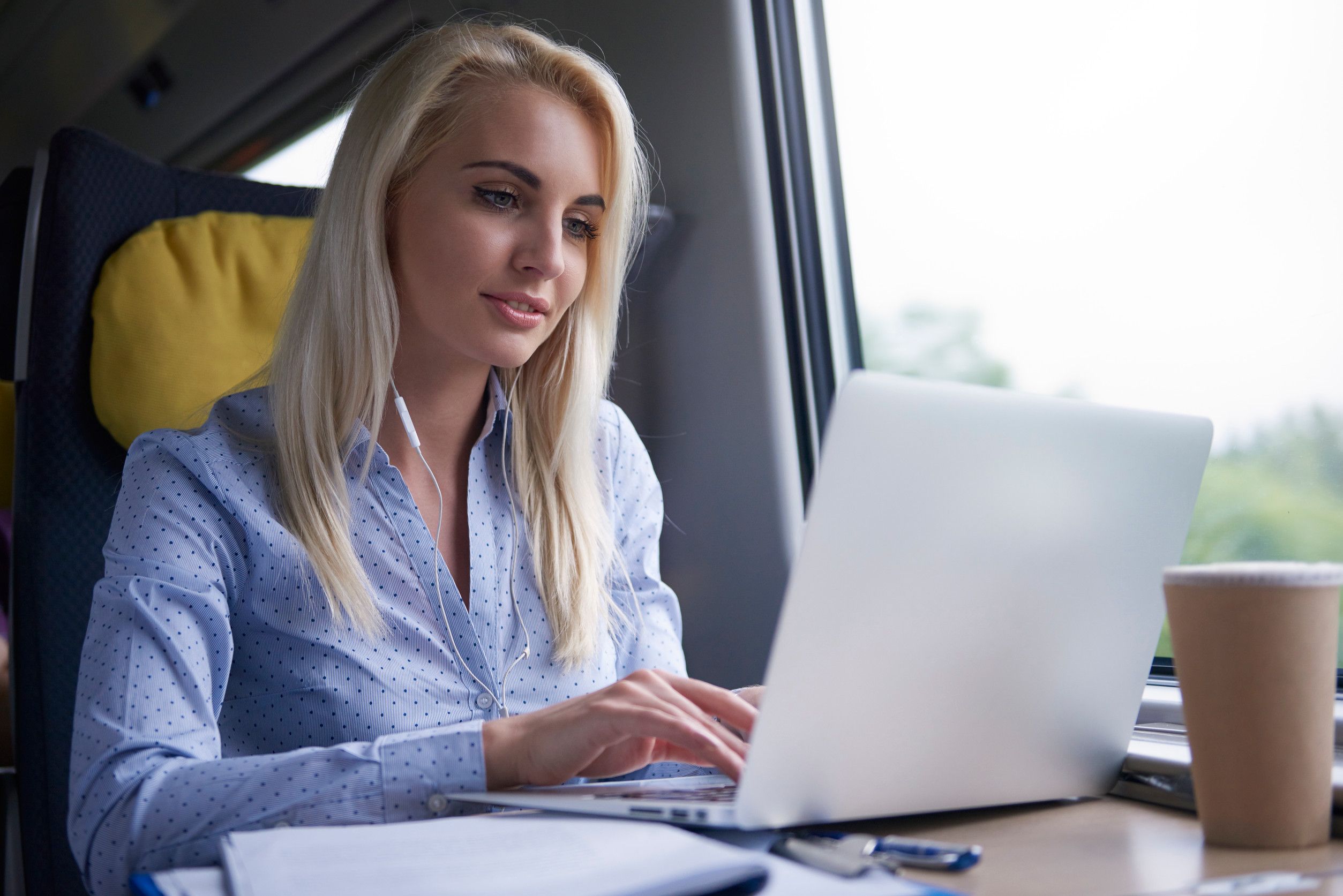 Employee using business application on laptop while travelling